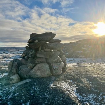 Stack of rocks in the tundra with sunshine