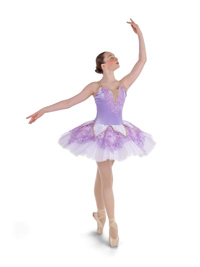 Ballerina in a lavender tutu gracefully posed on pointe against a white background.