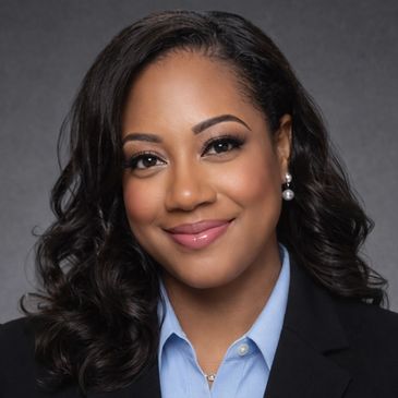 Professional woman with a warm smile in business attire.