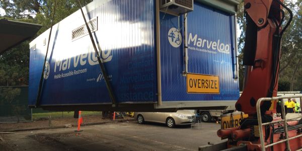 Marveloo is being lifted into place with a crane truck