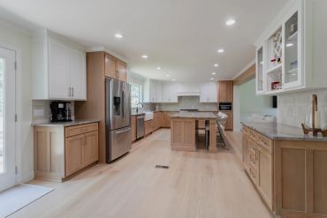 Modern kitchen with wooden cabinets and stainless steel appliances.