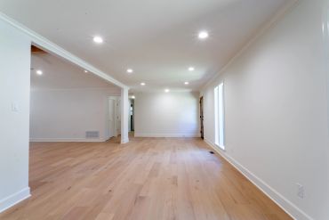 Empty room with wooden floor and white walls.