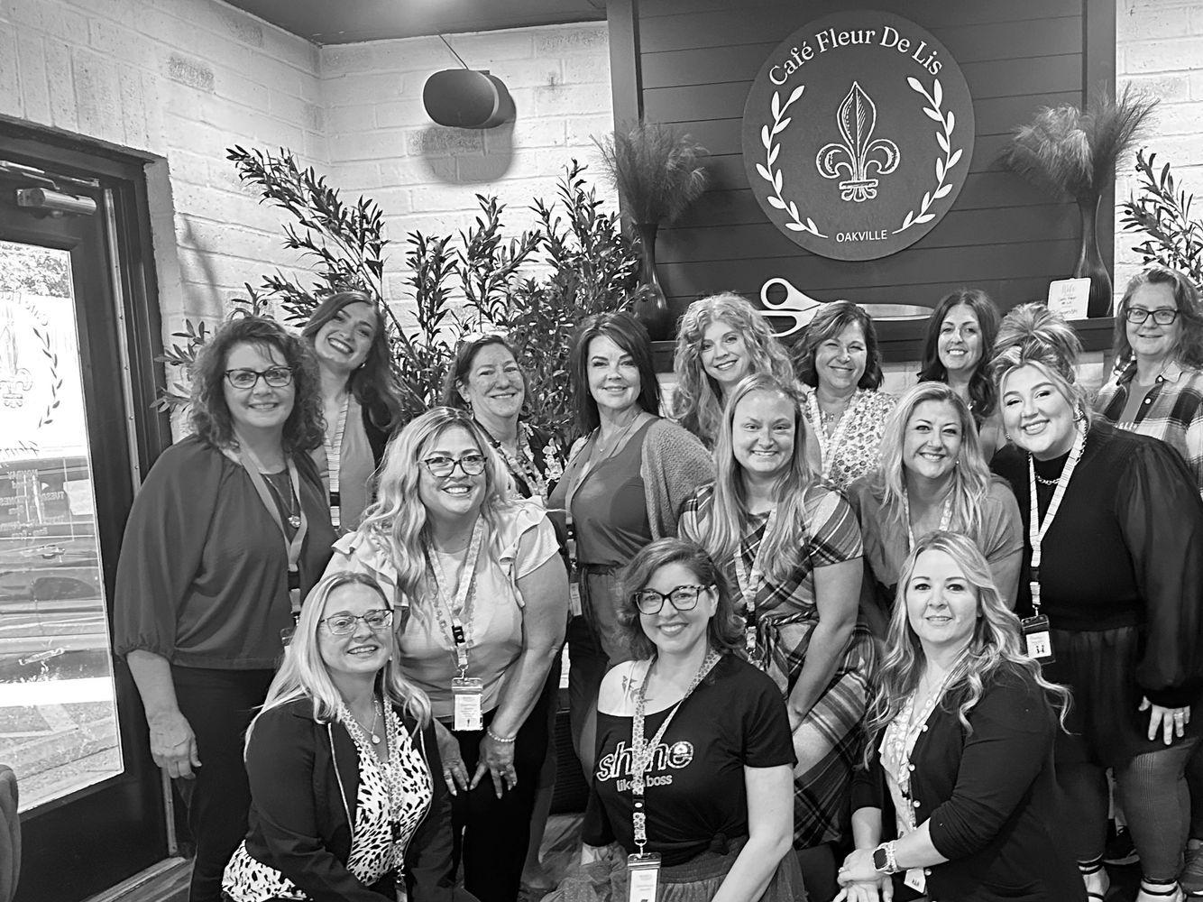 Group of women smiling inside Café Fleur De Lis in Oakville.