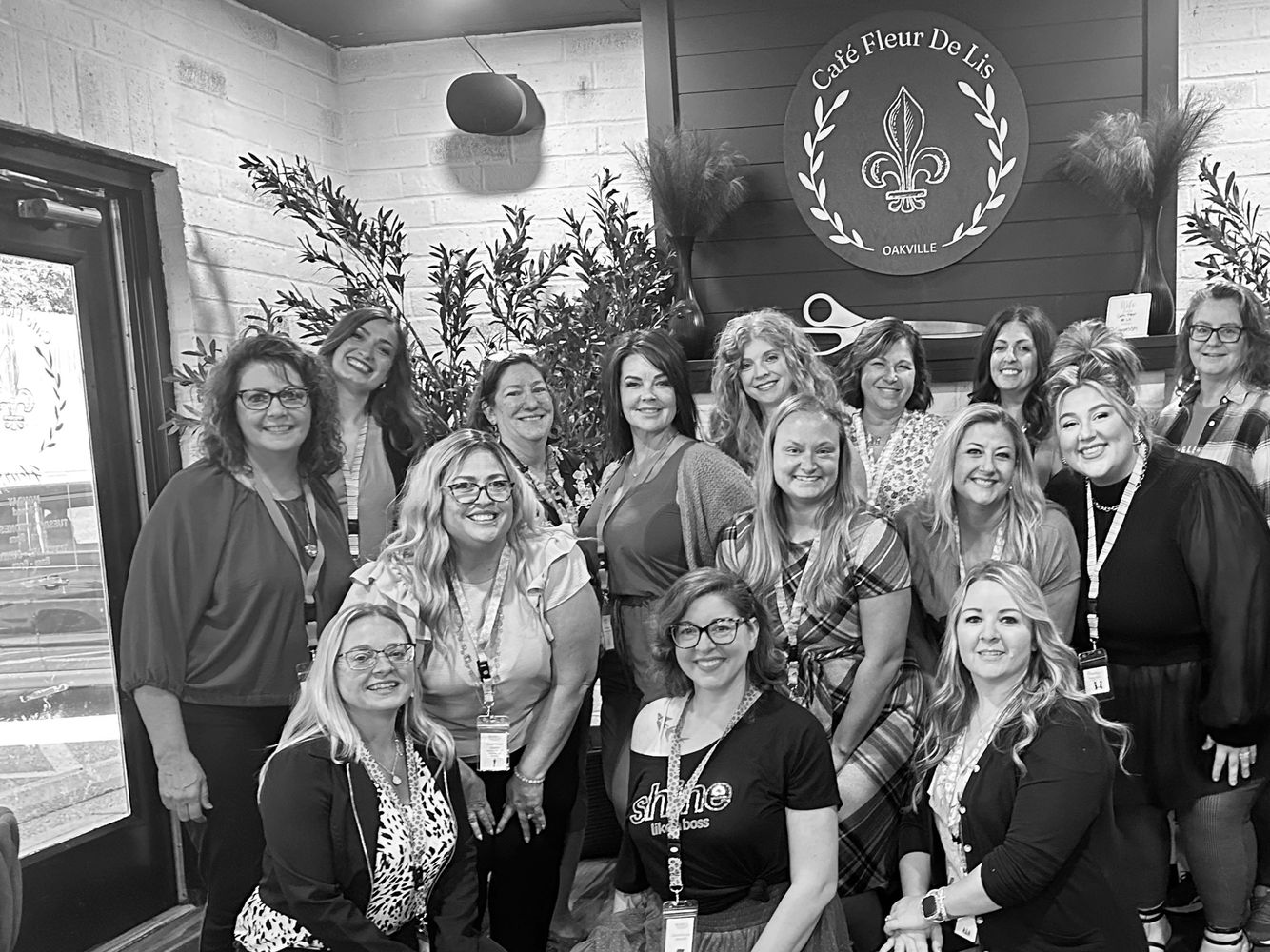 Group of women smiling inside Café Fleur De Lis in Oakville.