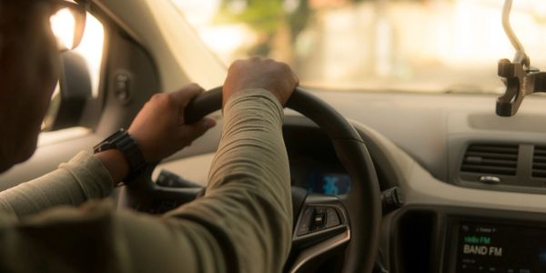 Hands on wheel of car