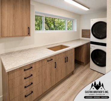 Modern laundry room with wooden cabinets and stacked washer-dryer.