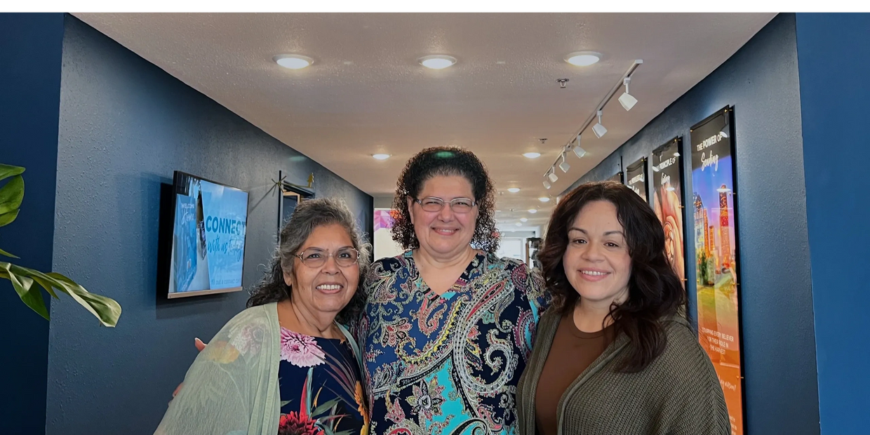 Group of three volunteers smiling