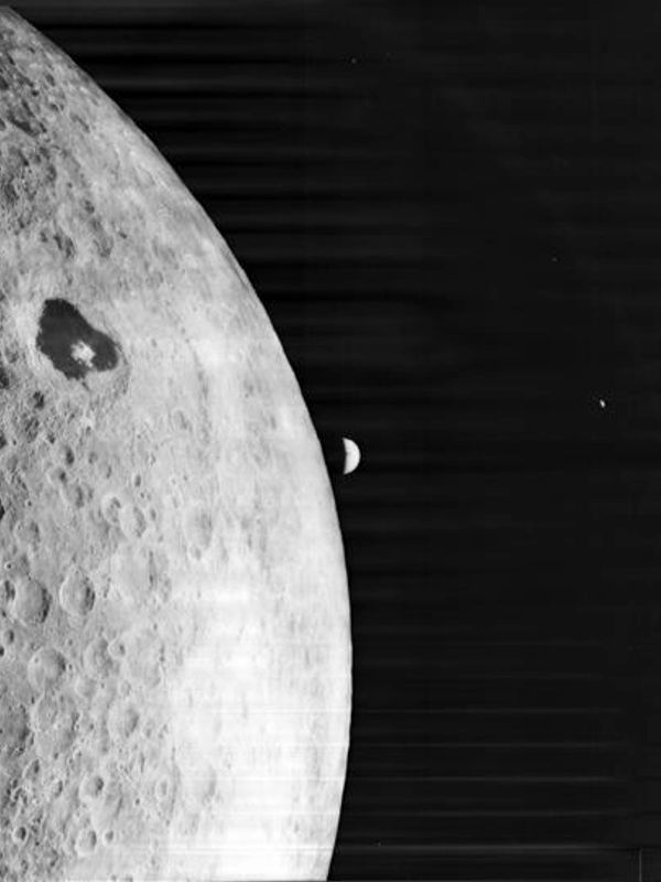 Close-up view of the Moon with Earth partially visible behind it.