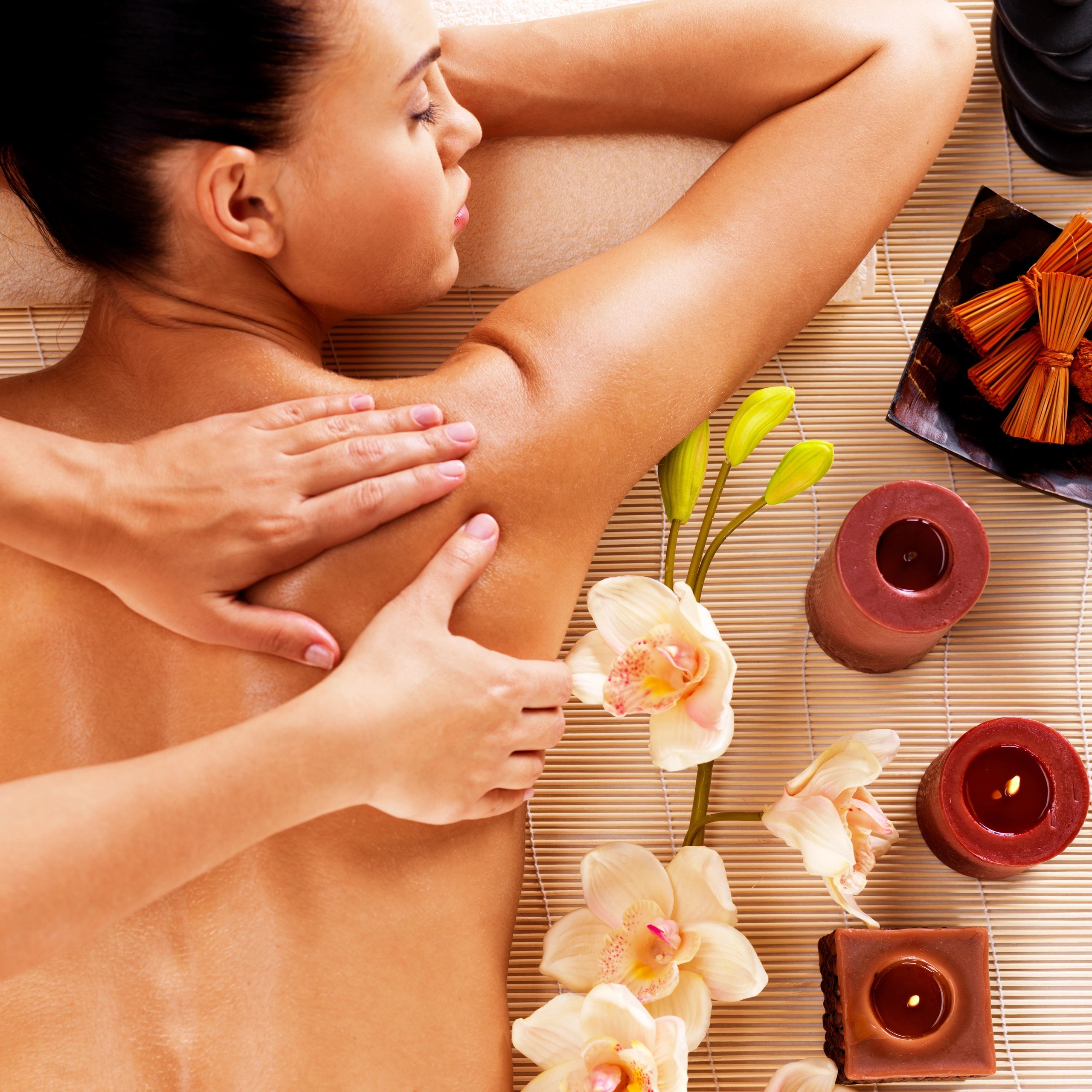 Adult woman in spa salon having relaxing body massage.
