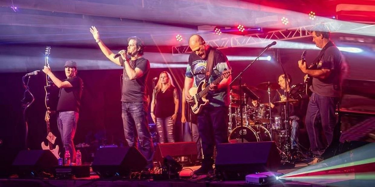 Live band performance with vibrant stage lighting and an engaged audience.