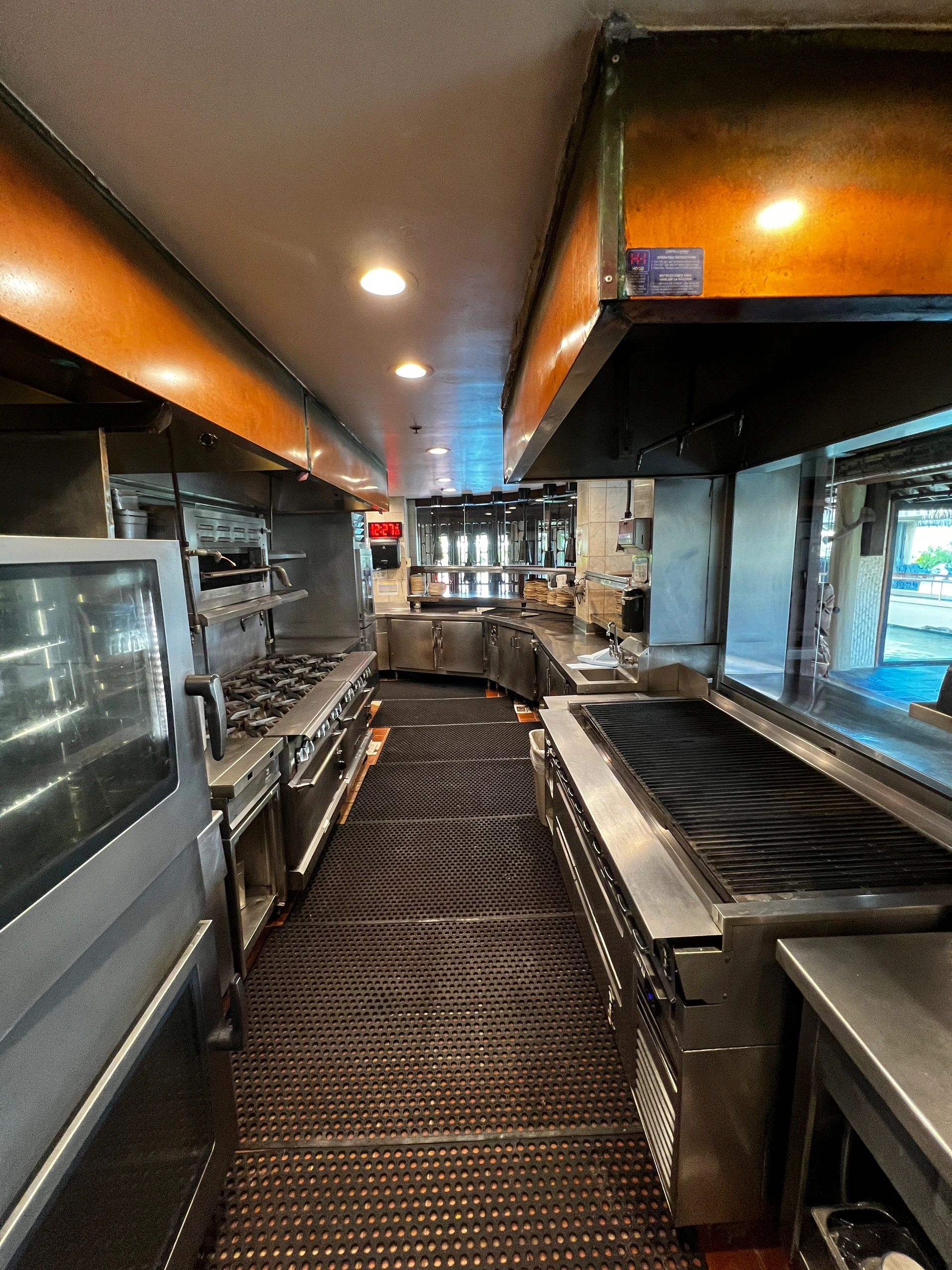Commercial kitchen with clean appliances and equipment.