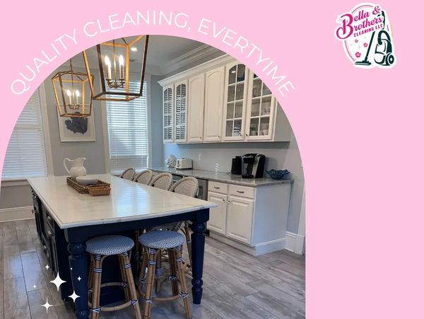 Clean, elegant kitchen with white cabinetry and blue island, highlighting quality cleaning service.