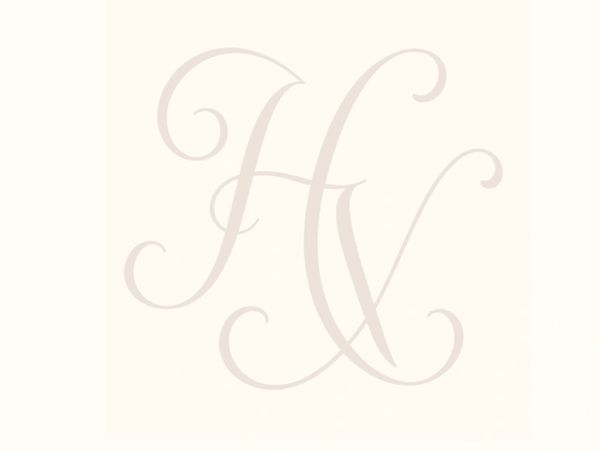 Elegant intertwined initials 'H' and 'V' in soft beige on a light background.