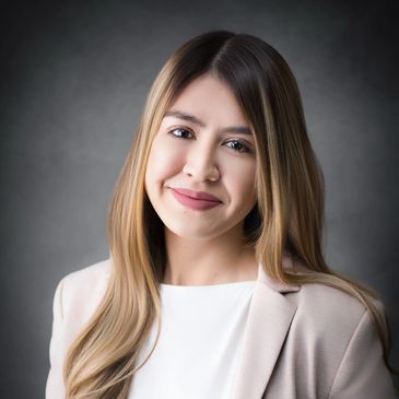 Professional headshot of a woman with long hair.