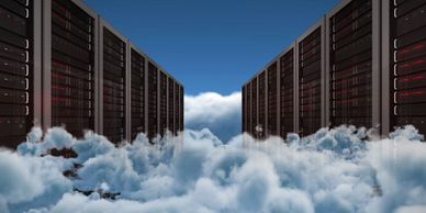 Data servers surrounded by clouds under a clear blue sky.