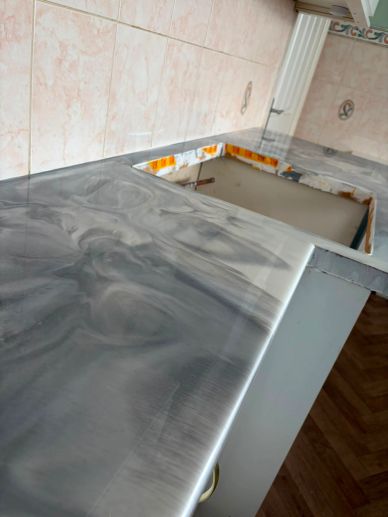 Newly installed grey marble countertop in kitchen.
