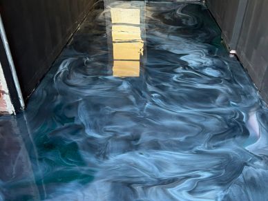 Room with shiny, marbled epoxy floor.
