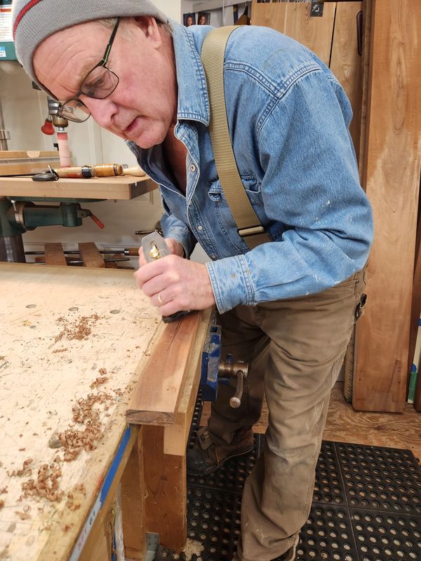 Hand planing a chair leg.