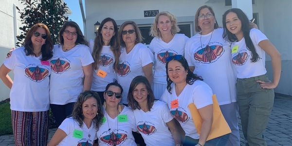 a group of women wearing white t shirts 