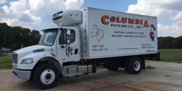White Columbia Packing Co. refrigerated truck parked outdoors.
