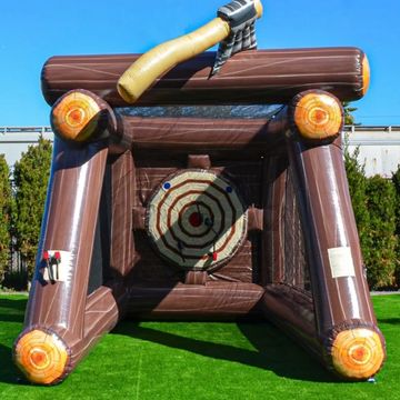 Inflatable axe throwing game with a target and axe on a grassy area.
