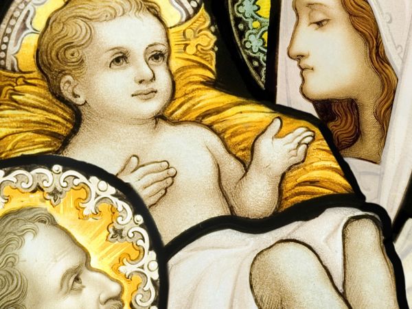 Religious stained glass depicting baby Jesus and saints.