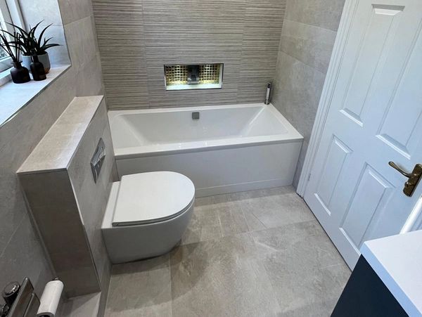 Modern bathroom with bathtub and toilet.