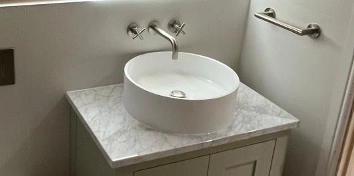 Modern bathroom sink with marble countertop.