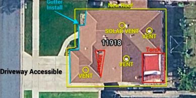 Aerial view of a property with roof annotations and driveway access.