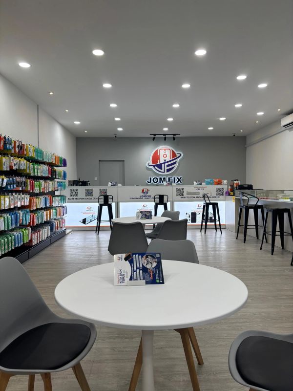 Modern phone repair shop with bright lighting and organized displays.