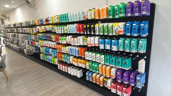 Wall display of colorful electronic accessories in a store.