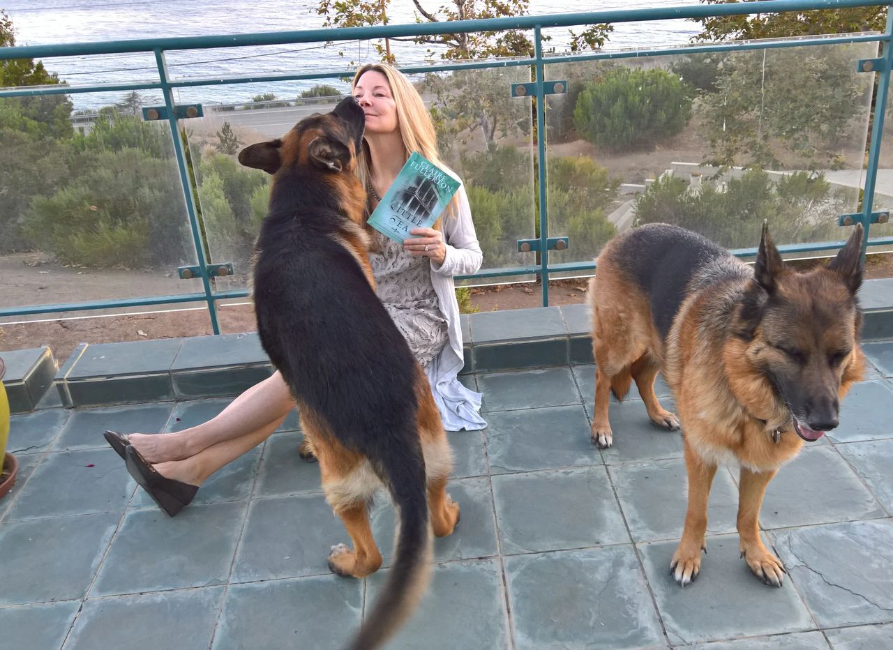 Author Claire Fullerton at her oceanfront home with her pups in Malibu, CA. Author Claire Fullerton at her oceanfront home with her pups in Malibu, CA.