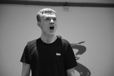 Young man passionately speaking or singing with mouth open.