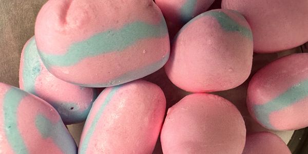 Pink and blue striped marshmallows piled together.