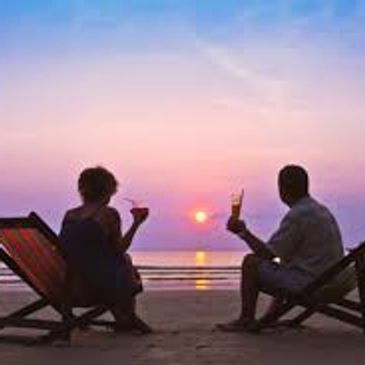2 people drinking and watching the sunset
