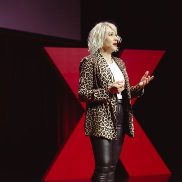 Tiana Iuvale standing on the TEDx Brisbane stage.