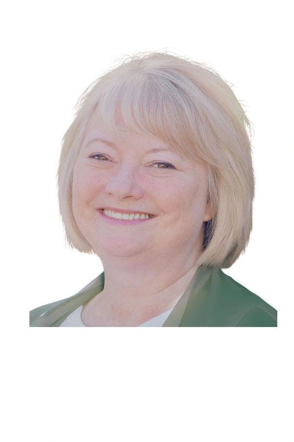 Smiling middle-aged woman with blonde hair and light makeup.
