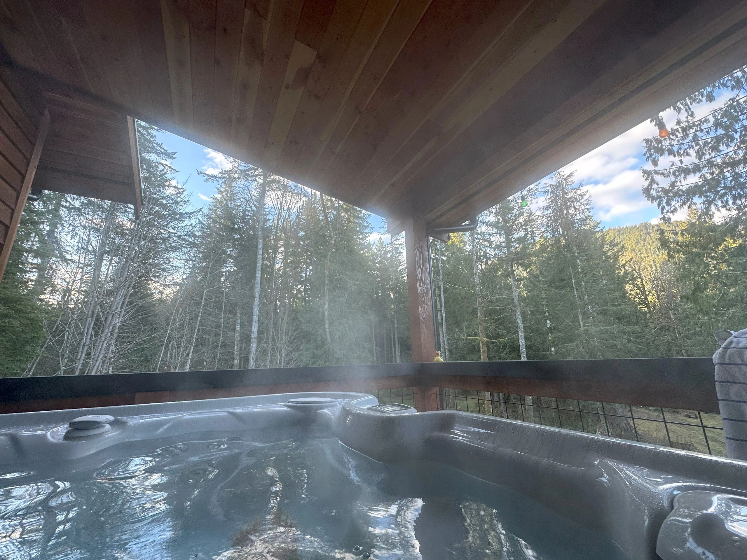 Relax in the hot tub conveniently located on the covered porch with views of surrounding forest.