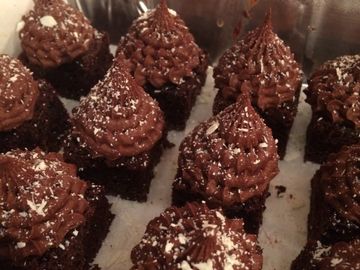 chocolate brownies with chocolate frosting that look like trees with snow