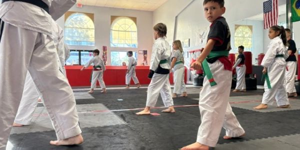 Children practicing martial arts in a dojo.