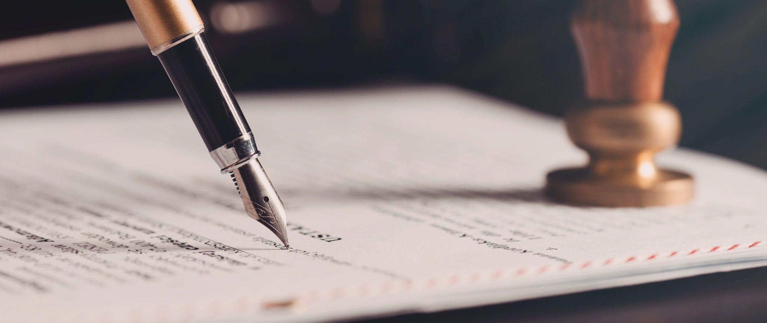 Lawyer reviewing contract with fountain pen