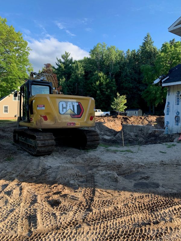 Yellow CAT excavator at a construction site.