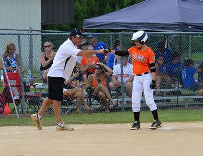 coach fist bumping a player with fans watching in background