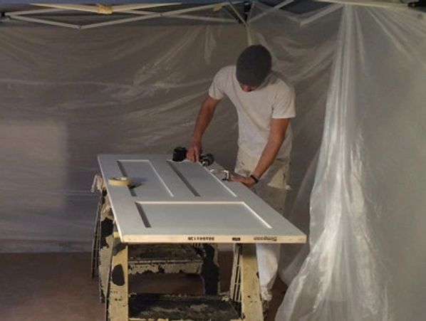 Residential painting company worker painting an interior door in Snohomish WA
