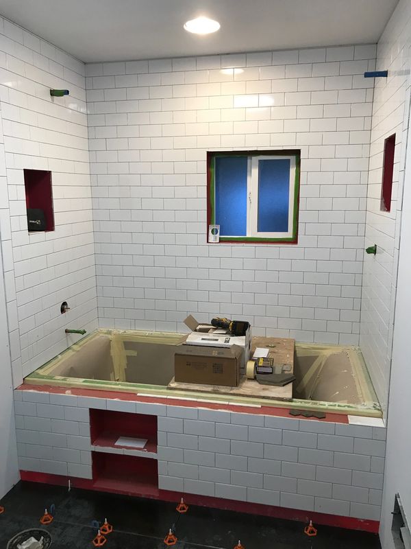 Tile contractor installing tile during a bathroom remodel, reflecting quality in Shohomish WA