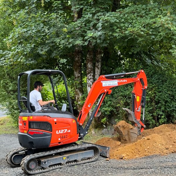 Excavation work digging a utility trench for a residential property in Snohomish County, Washington