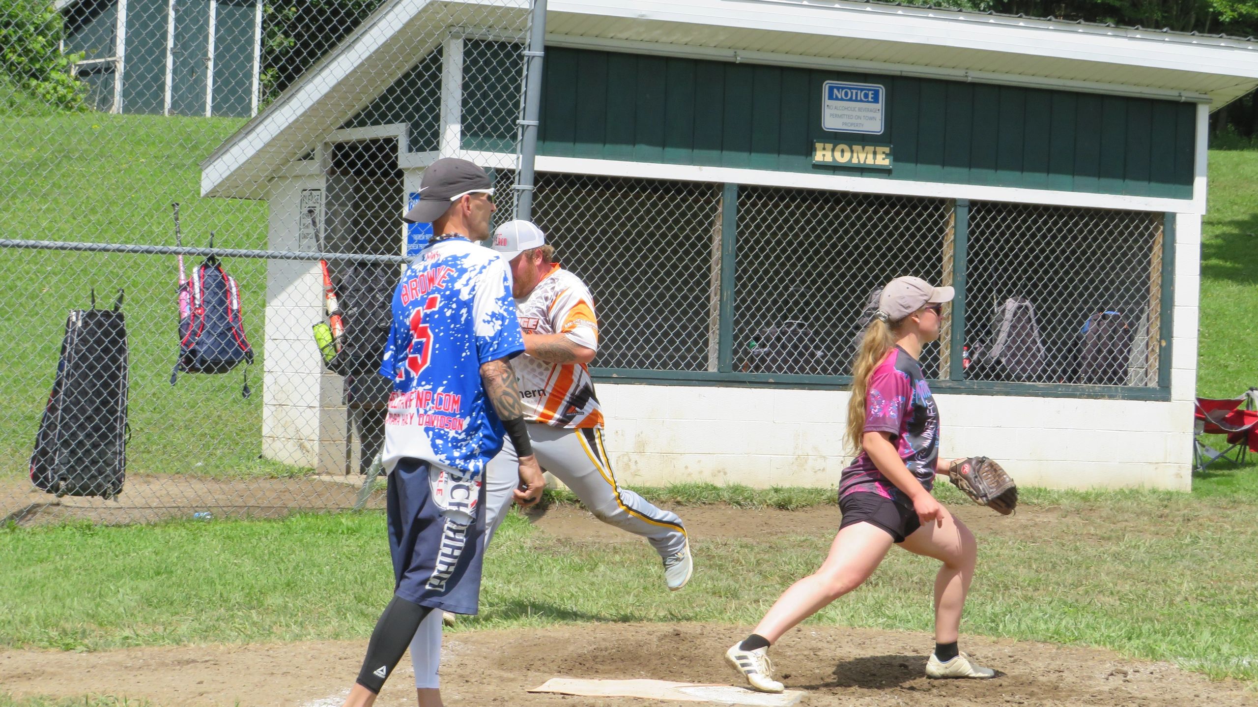 Softball game with players near the home plate.