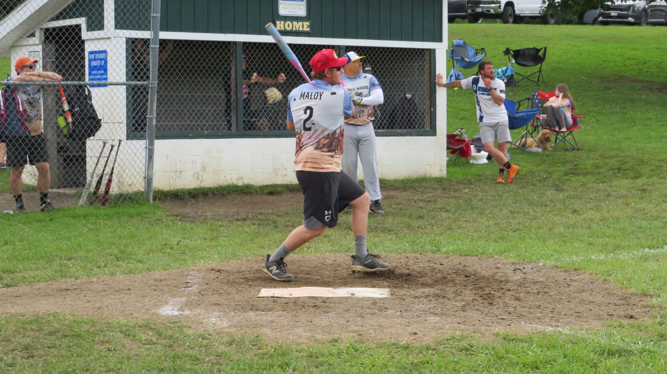A baseball player preparing to swing at a pitch in a local game.