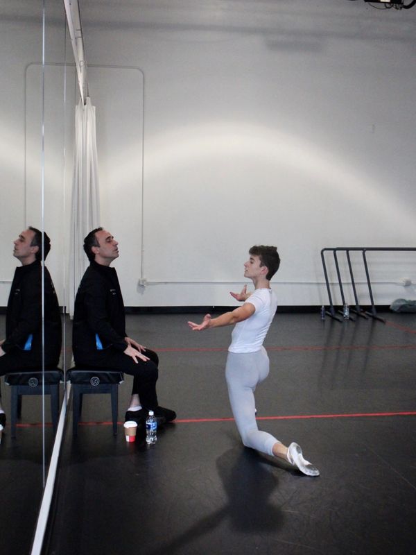 Ballet dancer practices while instructor watches.