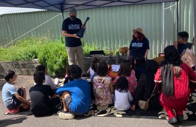 Music for Refugee founder Mr Feinstein distributes instruments given to him by Elza Banks.